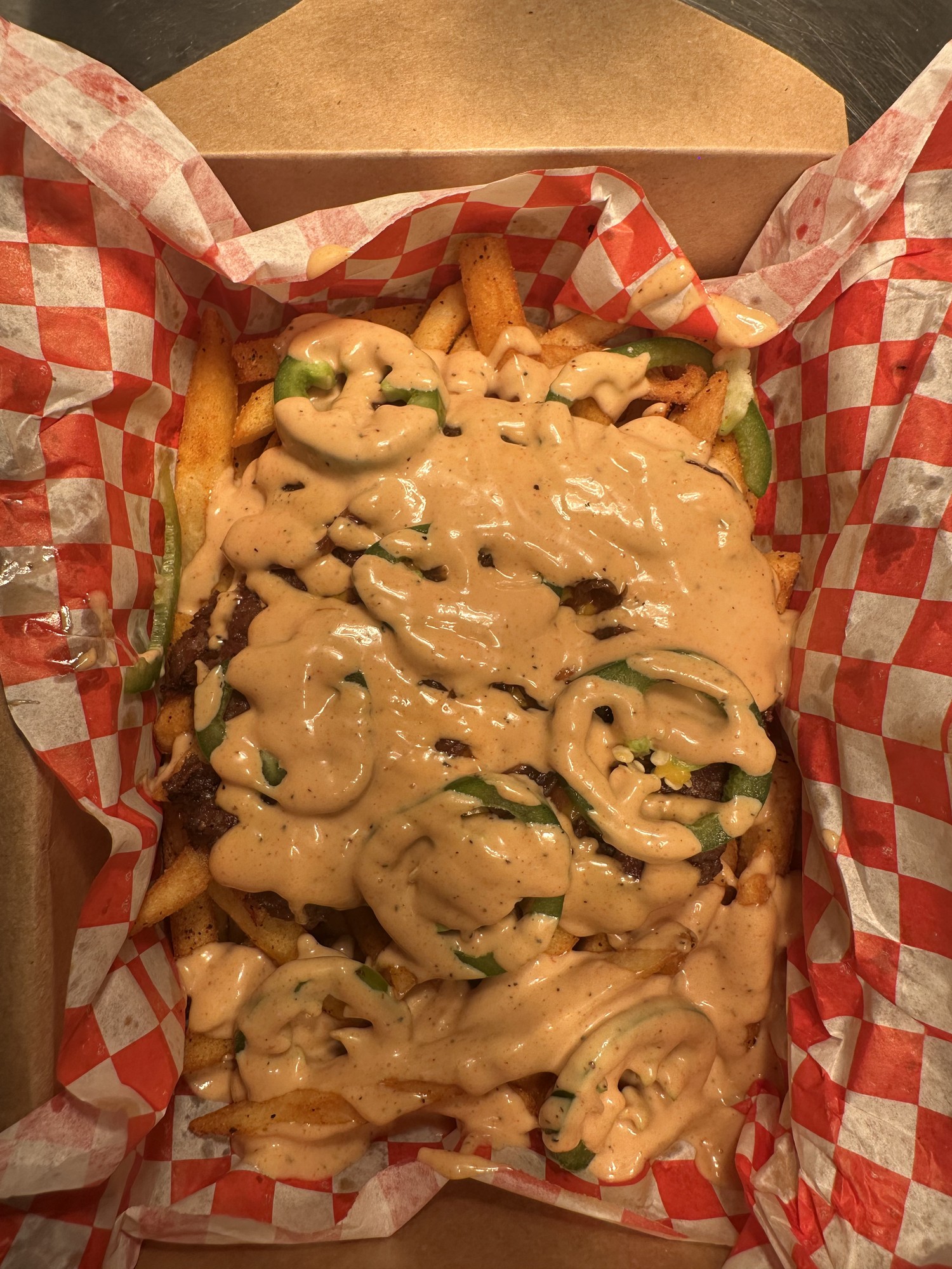 Bronze Fries loaded with smashed patty, jalapeños and Bronze sauce