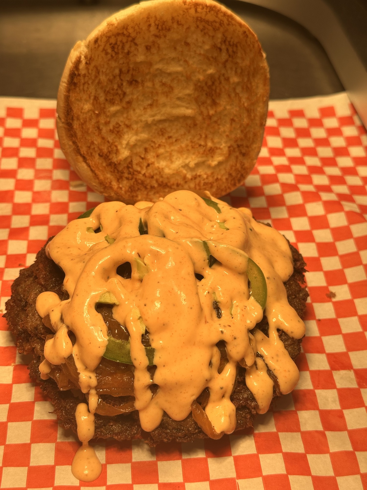 Jalapeño Bronze burger with grilled onions, jalapeños and Bronze sauce