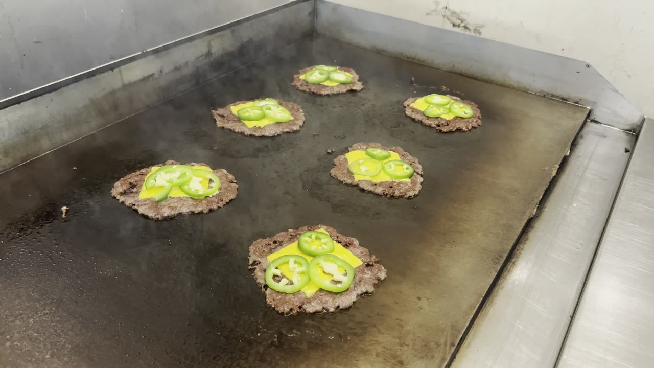 Smashing patties on the flat top at Bronze Burger